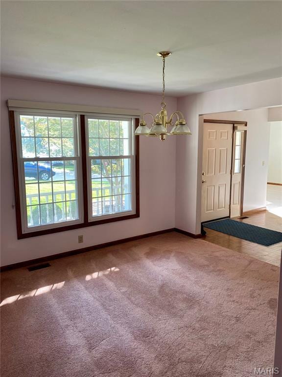 12020 Jacobson Ct, Saint Louis, MO 63044 - carpeted empty room with a chandelier and baseboards
