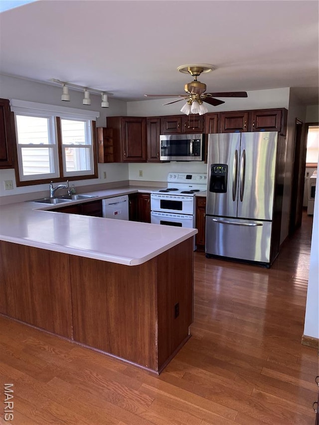 12020 Jacobson Ct, Saint Louis, MO 63044 - kitchen featuring appliances with stainless steel finishes, light countertops, a peninsula, and wood finished floors