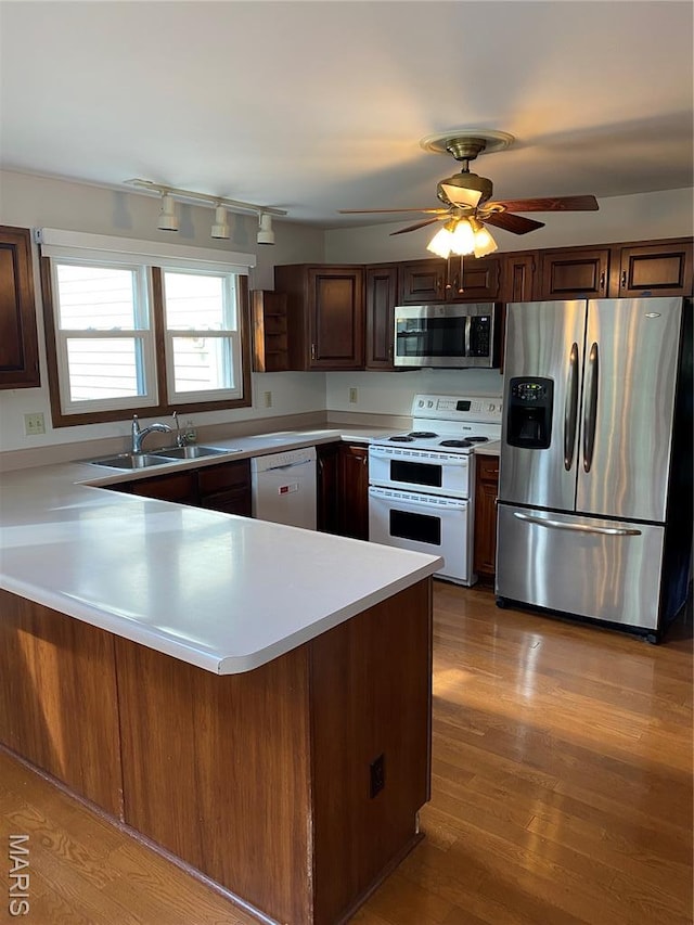 12020 Jacobson Ct, Saint Louis, MO 63044 - kitchen with appliances with stainless steel finishes, light countertops, a peninsula, rail lighting, and a ceiling fan