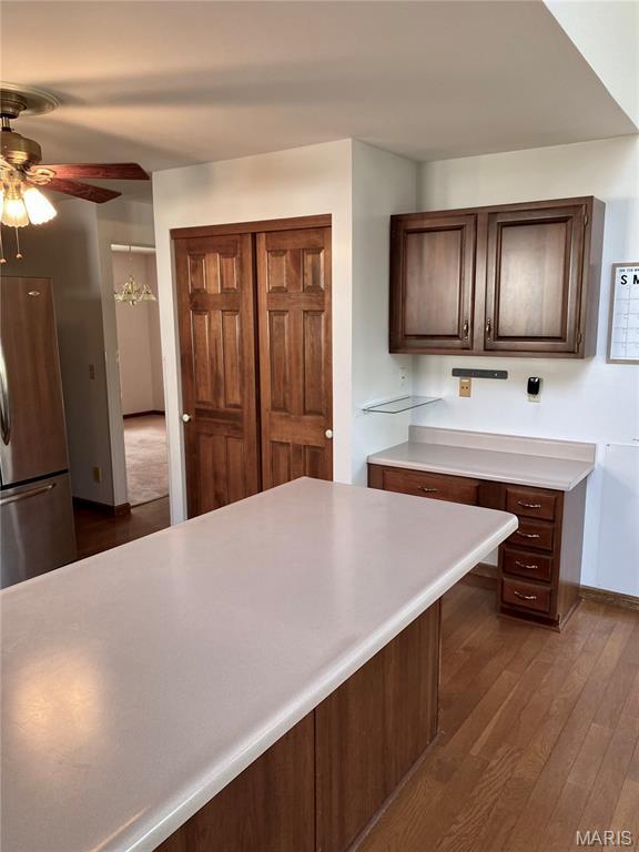 12020 Jacobson Ct, Saint Louis, MO 63044 - kitchen featuring freestanding refrigerator, ceiling fan, light countertops, and dark wood-type flooring