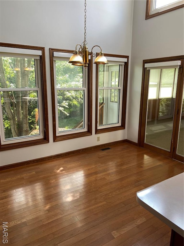 12020 Jacobson Ct, Saint Louis, MO 63044 - unfurnished dining area featuring a chandelier and hardwood / wood-style floors
