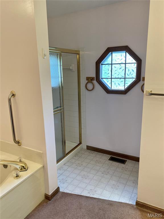 12020 Jacobson Ct, Saint Louis, MO 63044 - bathroom featuring a stall shower and a bath