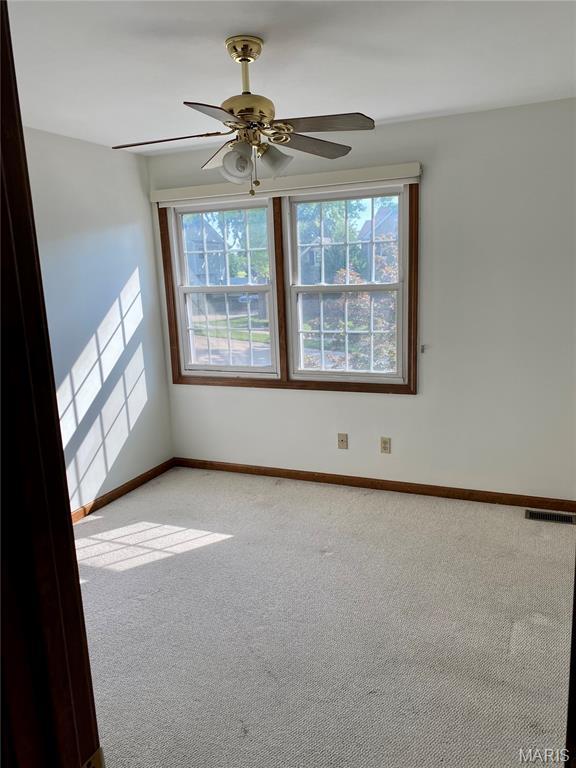 12020 Jacobson Ct, Saint Louis, MO 63044 - empty room featuring plenty of natural light, light carpet, and ceiling fan