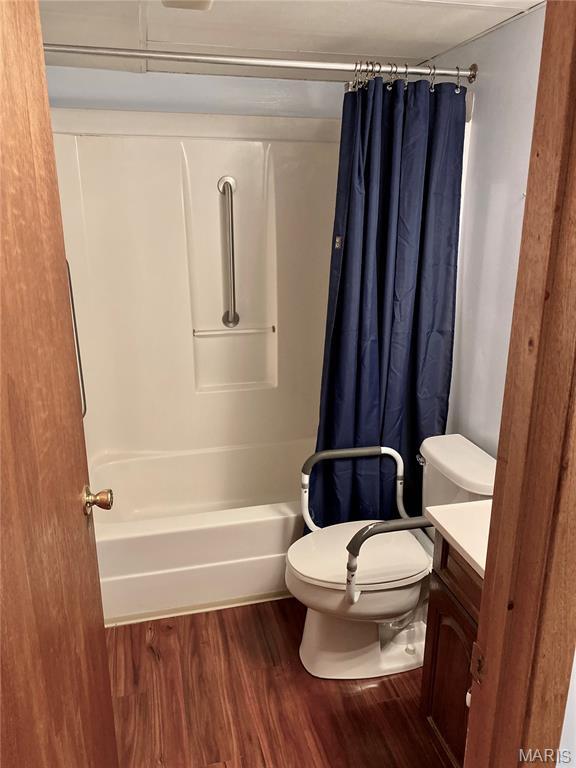 12020 Jacobson Ct, Saint Louis, MO 63044 - bathroom with vanity, wood finished floors, and shower / tub combo