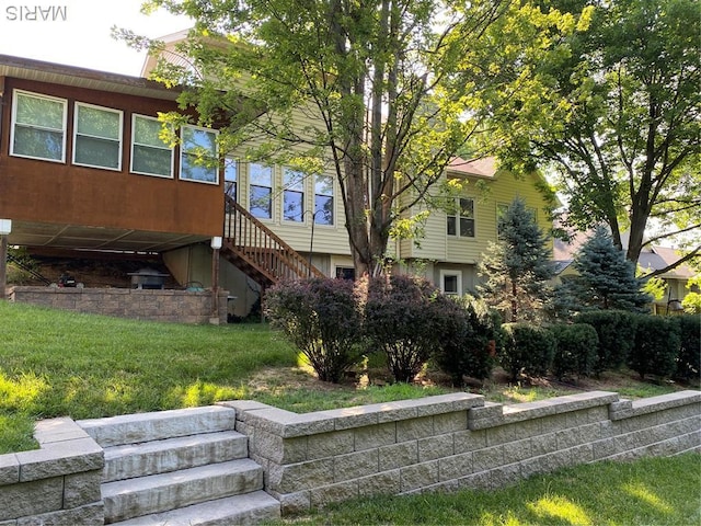12020 Jacobson Ct, Saint Louis, MO 63044 - back of house featuring stairway and a lawn