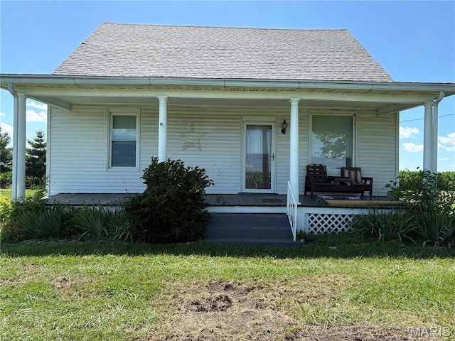 98 SW 200th Ave, Carrollton, IL 62016 - view of front of property with covered porch, a front yard, and roof with shingles