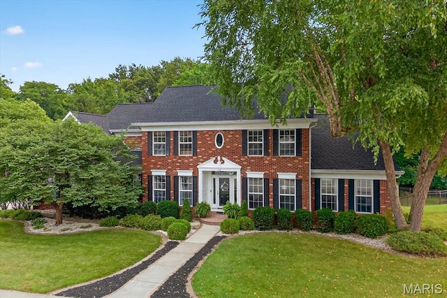 218 W Stonybrook Dr, Ofallon, IL 62269 - view of front of home with a front lawn, brick siding, and a shingled roof