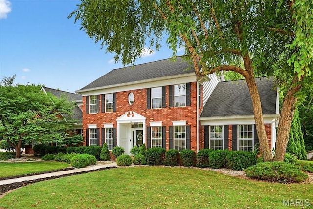 218 W Stonybrook Dr, Ofallon, IL 62269 - georgian-style home with a front lawn, brick siding, and a shingled roof