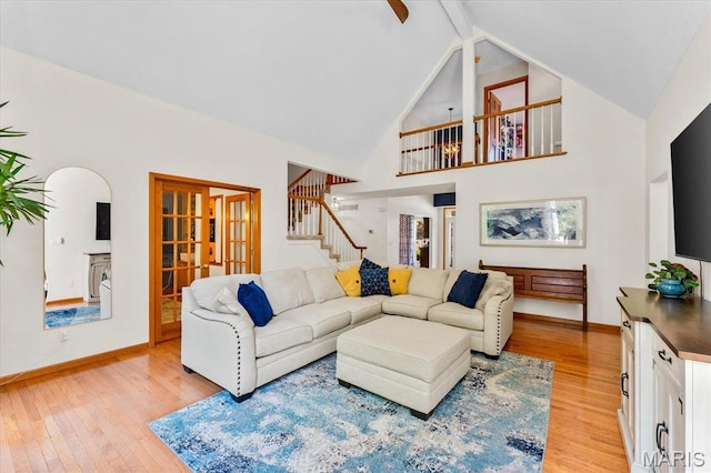 218 W Stonybrook Dr, Ofallon, IL 62269 - living area featuring light wood-style floors, stairs, beam ceiling, high vaulted ceiling, and arched walkways