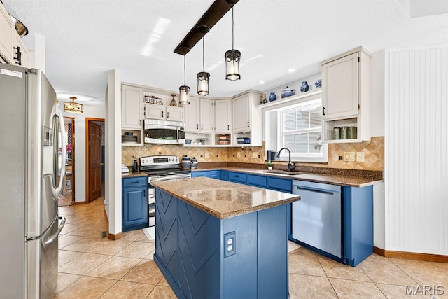 218 W Stonybrook Dr, Ofallon, IL 62269 - kitchen with stainless steel appliances, blue cabinets, light tile patterned flooring, and backsplash