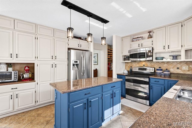 218 W Stonybrook Dr, Ofallon, IL 62269 - kitchen with appliances with stainless steel finishes, blue cabinets, open shelves, backsplash, and white cabinets