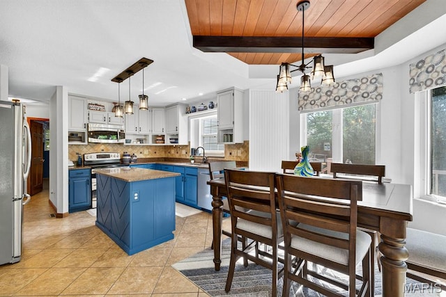 218 W Stonybrook Dr, Ofallon, IL 62269 - kitchen featuring blue cabinets, stainless steel appliances, tasteful backsplash, a chandelier, and light tile patterned floors