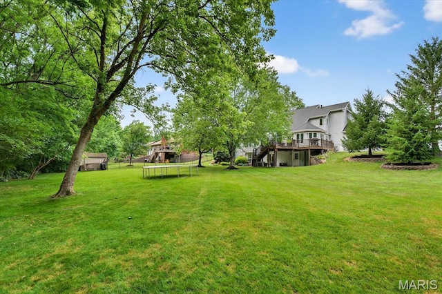 218 W Stonybrook Dr, Ofallon, IL 62269 - view of grassy yard with a trampoline, a wooden deck, and stairs