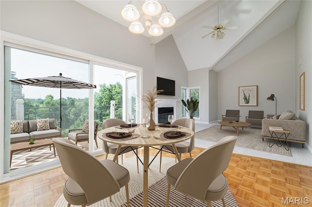 1632 Lake Knoll Dr Unit 1P, Lake St Louis, MO 63367 - dining area with high vaulted ceiling, healthy amount of natural light, a glass covered fireplace, a chandelier, and a ceiling fan