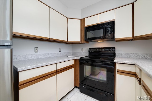 1632 Lake Knoll Dr Unit 1P, Lake St Louis, MO 63367 - kitchen with black appliances, light countertops, white cabinets, and light tile patterned floors