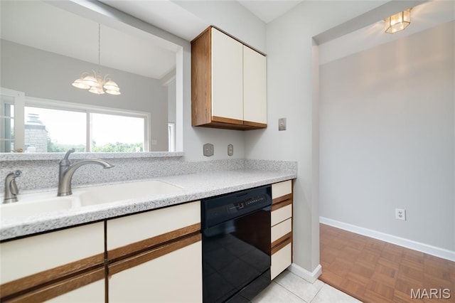 1632 Lake Knoll Dr Unit 1P, Lake St Louis, MO 63367 - kitchen with black dishwasher, a chandelier, white cabinets, and hanging light fixtures