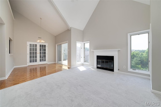 1632 Lake Knoll Dr Unit 1P, Lake St Louis, MO 63367 - unfurnished living room with high vaulted ceiling, carpet floors, plenty of natural light, a chandelier, and a fireplace with flush hearth