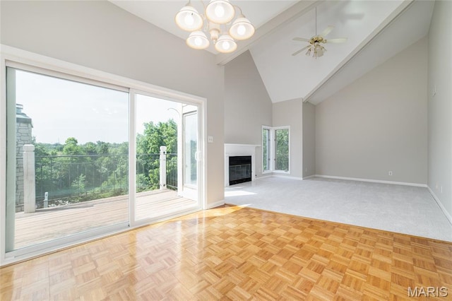 1632 Lake Knoll Dr Unit 1P, Lake St Louis, MO 63367 - unfurnished living room with healthy amount of natural light, high vaulted ceiling, a chandelier, a ceiling fan, and a glass covered fireplace