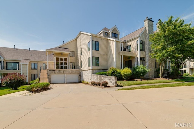 1632 Lake Knoll Dr Unit 1P, Lake St Louis, MO 63367 - view of property with an attached garage and driveway
