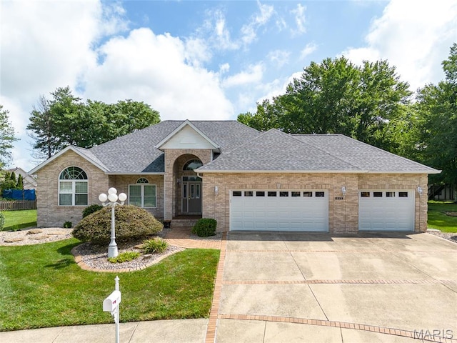 1805 Lincoln Knolls Dr, Edwardsville, IL 62025 - view of front facade with driveway, an attached garage, a front lawn, and brick siding