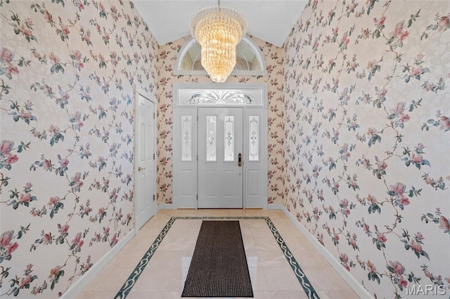 1805 Lincoln Knolls Dr, Edwardsville, IL 62025 - entrance foyer with wallpapered walls, a chandelier, inlaid floor details, and lofted ceiling
