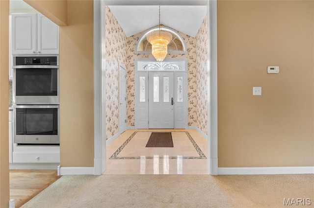 1805 Lincoln Knolls Dr, Edwardsville, IL 62025 - entrance foyer featuring wallpapered walls, a chandelier, light colored carpet, and vaulted ceiling