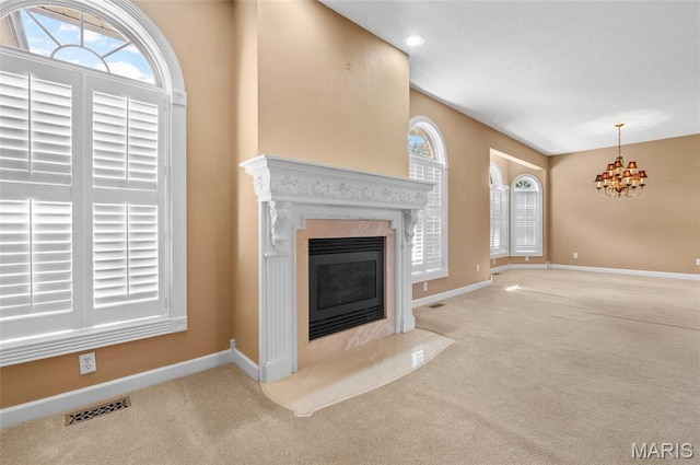 1805 Lincoln Knolls Dr, Edwardsville, IL 62025 - unfurnished living room with carpet floors, a chandelier, and a premium fireplace