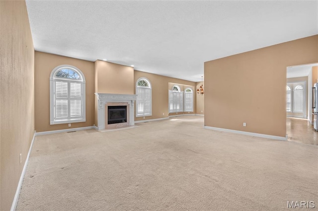 1805 Lincoln Knolls Dr, Edwardsville, IL 62025 - unfurnished living room featuring healthy amount of natural light, a fireplace with flush hearth, and carpet floors