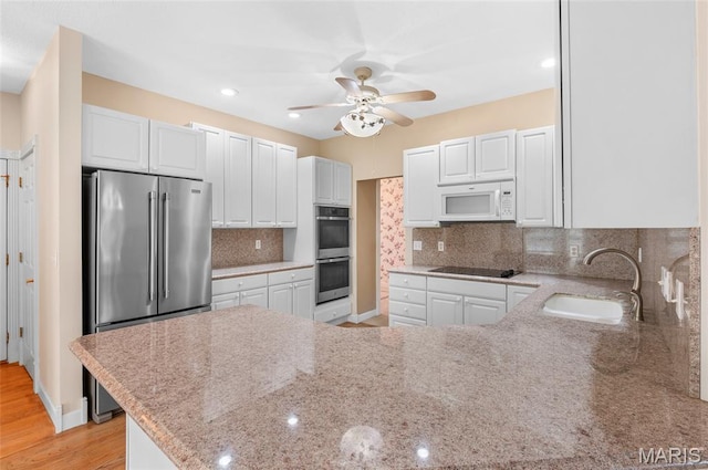 1805 Lincoln Knolls Dr, Edwardsville, IL 62025 - kitchen with appliances with stainless steel finishes, a peninsula, a ceiling fan, and white cabinetry