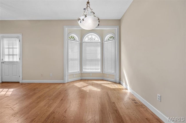 1805 Lincoln Knolls Dr, Edwardsville, IL 62025 - unfurnished dining area featuring baseboards and light wood-style flooring