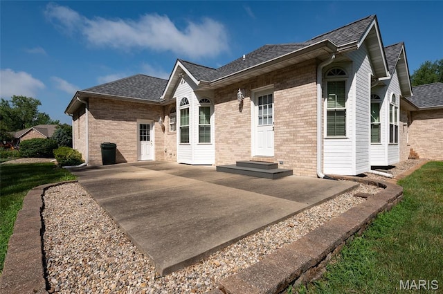 1805 Lincoln Knolls Dr, Edwardsville, IL 62025 - view of property exterior featuring brick siding, a patio, and roof with shingles