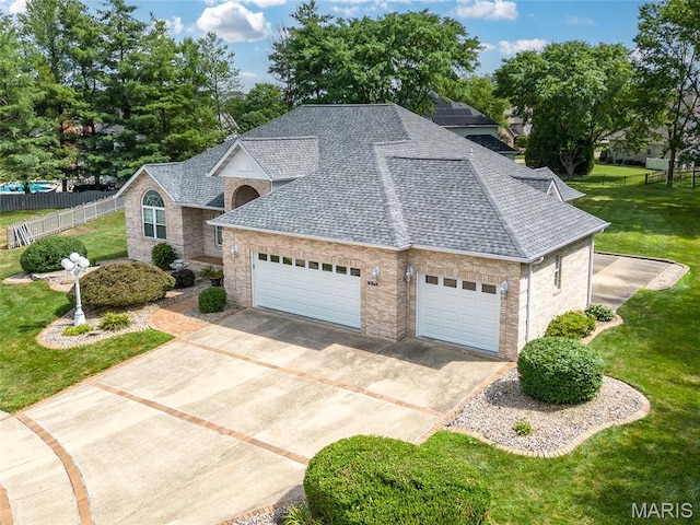 1805 Lincoln Knolls Dr, Edwardsville, IL 62025 - view of front of property with a shingled roof, driveway, brick siding, and a garage