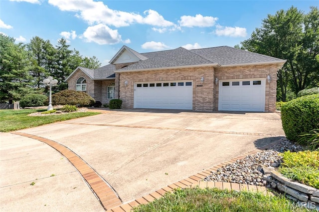 1805 Lincoln Knolls Dr, Edwardsville, IL 62025 - view of front facade featuring concrete driveway, a garage, a shingled roof, and brick siding