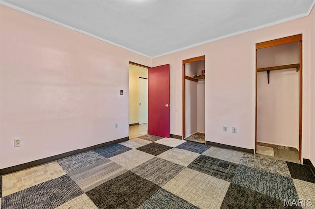 2 Willow Dr, Fairview Heights, IL 62208 - unfurnished bedroom with two closets, ornamental molding, and carpet flooring