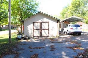 805 N Carleton, Farmington, MO 63640 - view of shed featuring a detached carport and asphalt driveway