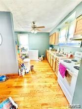 805 N Carleton, Farmington, MO 63640 - kitchen featuring white range with electric stovetop, healthy amount of natural light, a ceiling fan, and wood finished floors