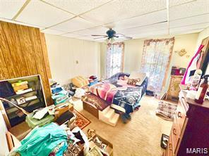 805 N Carleton, Farmington, MO 63640 - bedroom with a drop ceiling, wooden walls, and ceiling fan