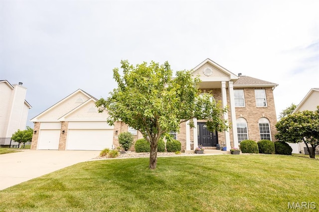 804 Cardiff Ct, Ofallon, IL 62269 - greek revival house with a front yard, driveway, brick siding, and a garage