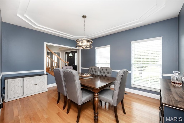 804 Cardiff Ct, Ofallon, IL 62269 - dining space featuring a raised ceiling, a chandelier, light wood-style flooring, and stairway