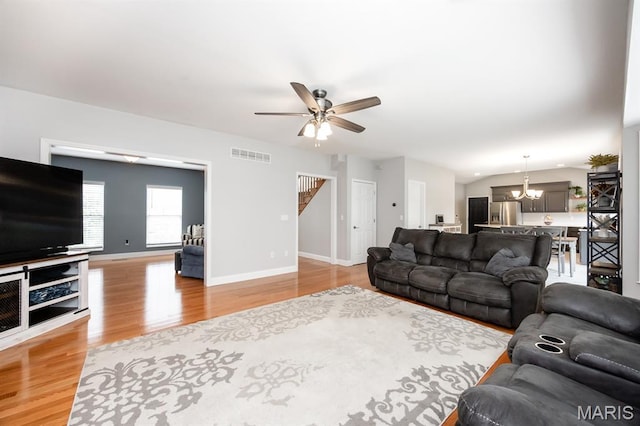 804 Cardiff Ct, Ofallon, IL 62269 - living room with a ceiling fan, light wood-style flooring, a chandelier, and stairway