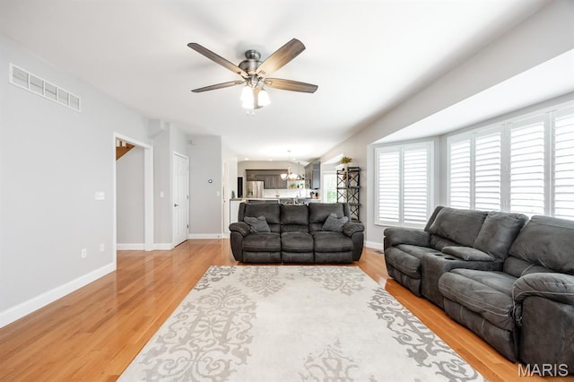 804 Cardiff Ct, Ofallon, IL 62269 - living room with ceiling fan, light wood finished floors, and a chandelier