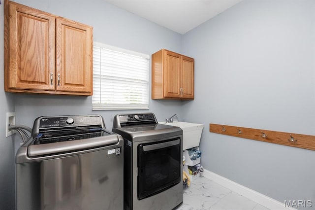 804 Cardiff Ct, Ofallon, IL 62269 - washroom featuring washing machine and dryer, cabinet space, and marble look tiles