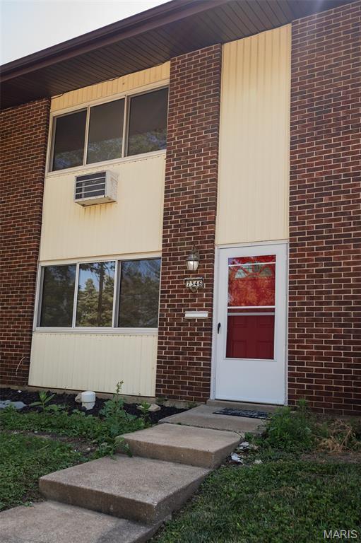 7346 Hazelcrest Dr, Hazelwood, MO 63042 - doorway to property with brick siding