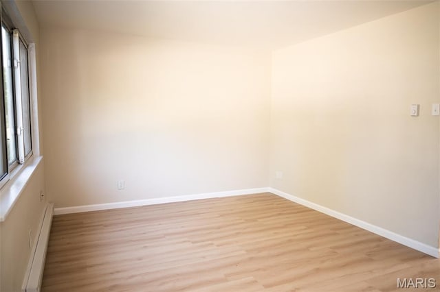 7346 Hazelcrest Dr, Hazelwood, MO 63042 - unfurnished room featuring baseboard heating and light wood-type flooring