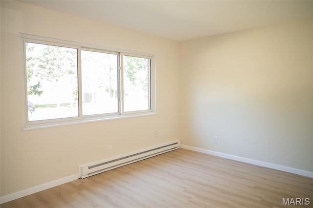 7346 Hazelcrest Dr, Hazelwood, MO 63042 - unfurnished room featuring a baseboard radiator and light wood finished floors
