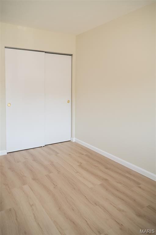 7346 Hazelcrest Dr, Hazelwood, MO 63042 - unfurnished bedroom with light wood finished floors and a closet
