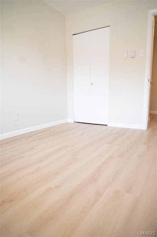 7346 Hazelcrest Dr, Hazelwood, MO 63042 - unfurnished bedroom featuring light wood finished floors and a closet