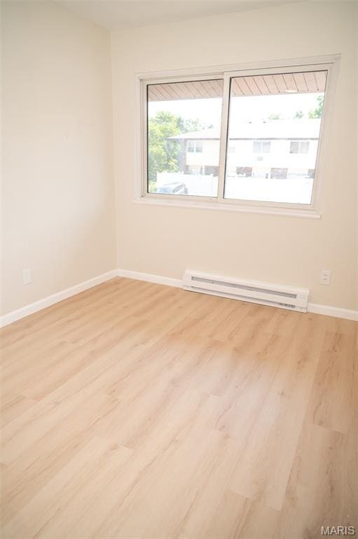 7346 Hazelcrest Dr, Hazelwood, MO 63042 - spare room featuring baseboard heating and light wood-style flooring