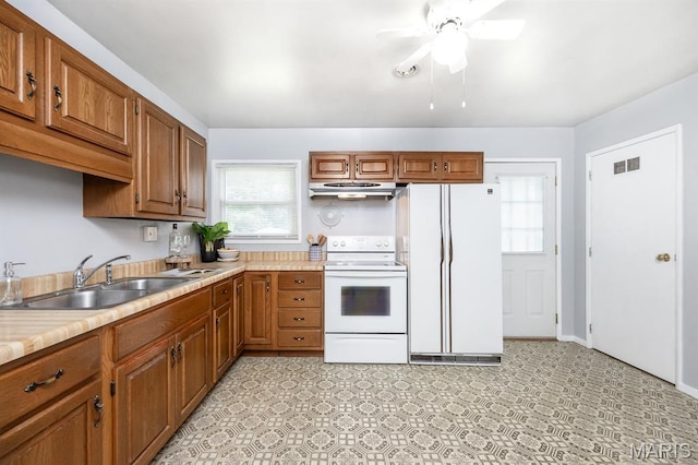 508 Joy Dr, Ofallon, IL 62269 - kitchen with white appliances, under cabinet range hood, plenty of natural light, and light countertops