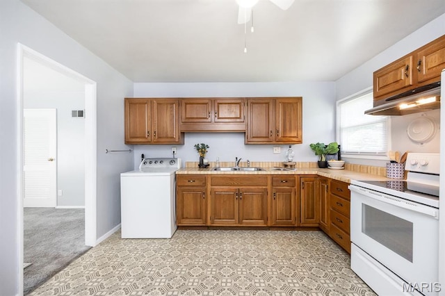 508 Joy Dr, Ofallon, IL 62269 - kitchen featuring electric range, washer / clothes dryer, under cabinet range hood, and brown cabinets